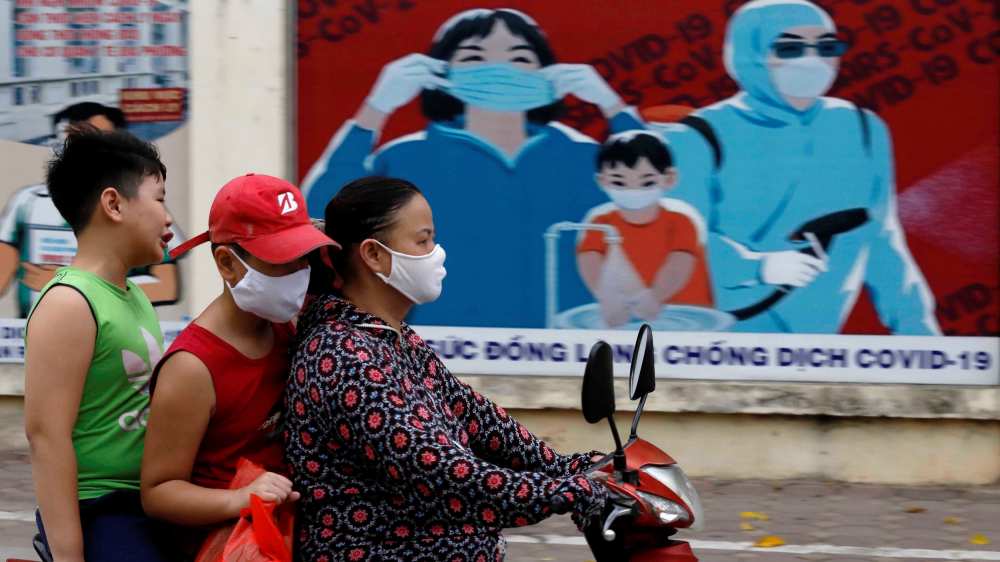 Vietnamese woman ride motobike at Covid time in Vietnam